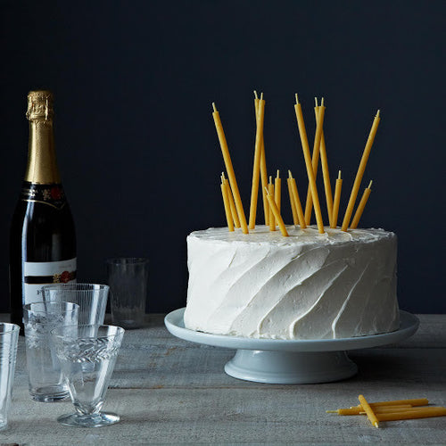 Natural beeswax birthday candles on a cake
