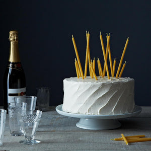 Natural beeswax birthday candles on a cake